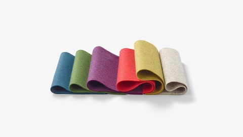 Folded, multicolor materials swatches laid out in a row.