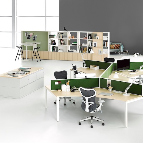 A workspace with two 120-degree Layout Studio workstations with privacy screens and Mirra 2 Chairs, lateral files, and Locale storage and bookcase. A workspace with two 120-degree Layout Studio workstations with privacy screens and Mirra 2 Chairs, lateral files, and Locale storage and bookcase.