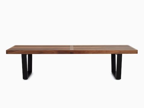Benching con plataforma Nelson en nogal, con patas de madera teñida de negro, visto desde el frente.